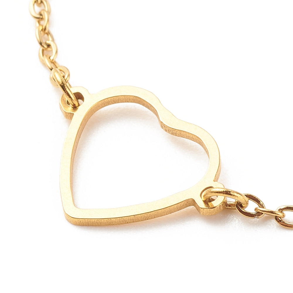 zoomed in golden center heart focal on cable chain on white background. 