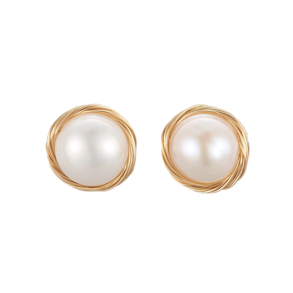 large white freshwater pearl stud earrings with golden wire wrapped "nest" surrounding pearl over white background. 