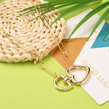 zoomed in plated brass swivel heart clasp on paperclip link chain displayed over a colorful background. 