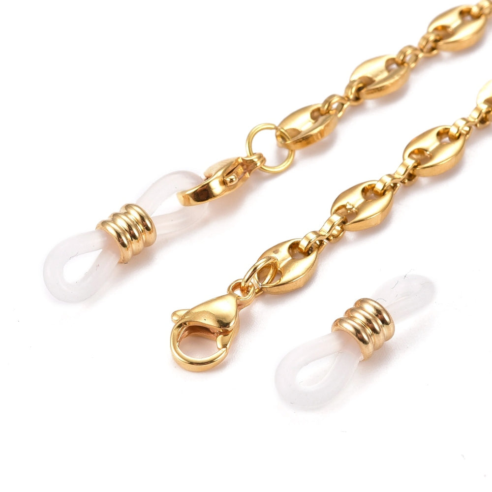 zoomed in golden lobster claw clasps and rubber loop ends of coffee bean link chain on white background. 