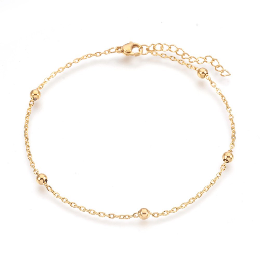 golden satellite chain anklet with lobster claw clasp and extender chain over white background. 