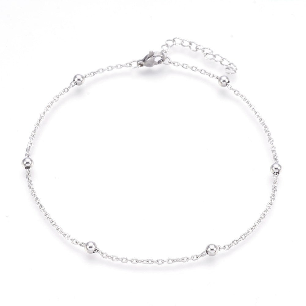 silver tone satellite chain anklet with lobster claw clasp and extender chain over white background. 