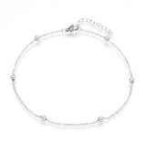 silver tone satellite chain anklet with lobster claw clasp and extender chain over white background. 