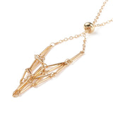 zoomed in section of golden adjustable macrame style pouch necklace with slider bead over white background. 