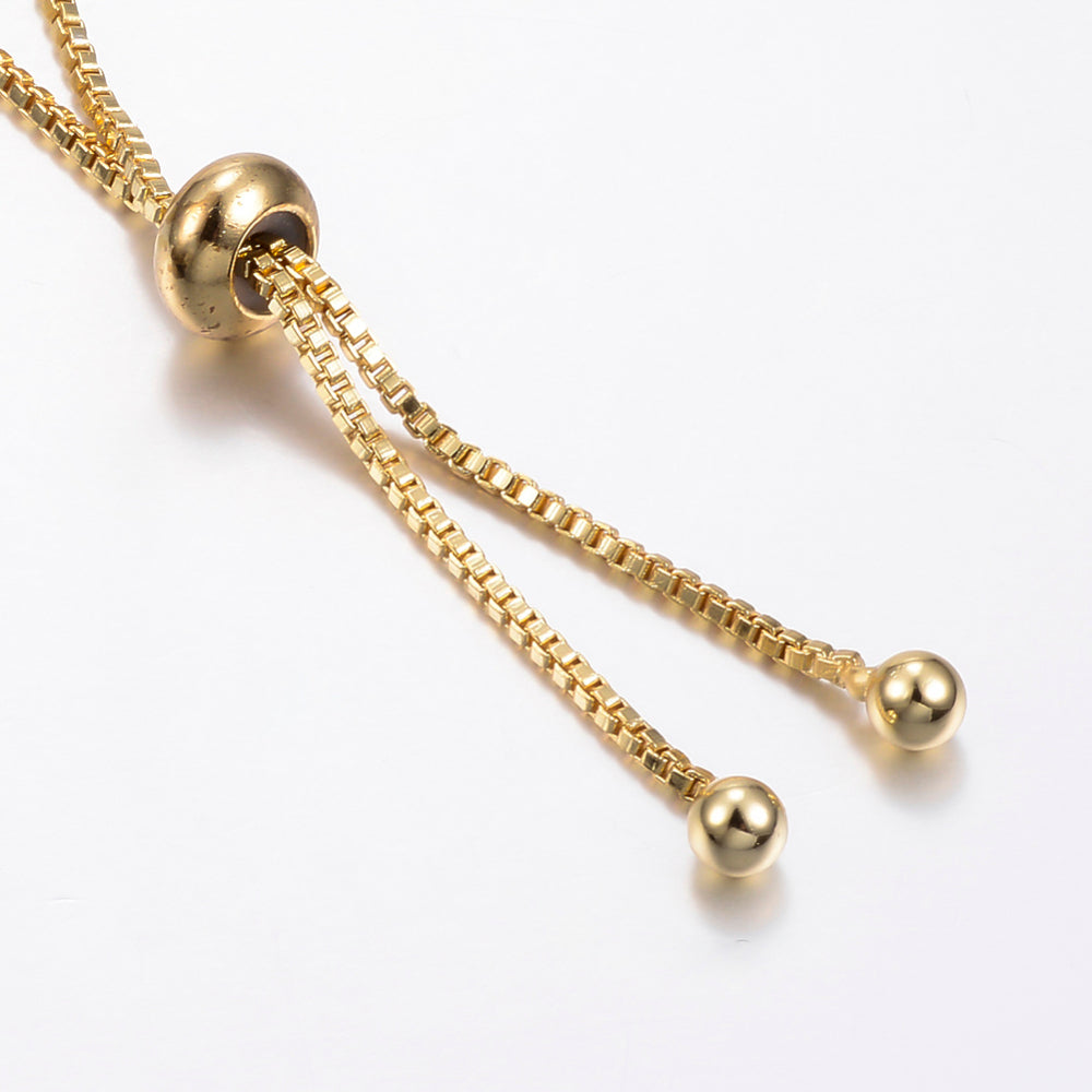 zoomed in golden bolo style adjustable clasp on white background. 