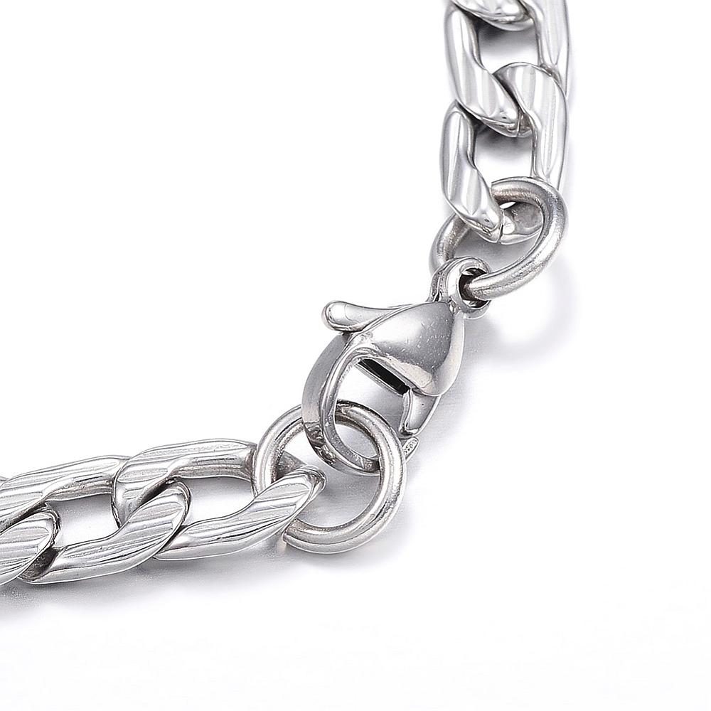 zoomed in section of silver tone textured Figaro chain bracelet with lobster claw on white background. 