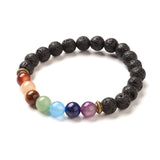 black lava chakra bead bracelet featuring seven round chakra stone beads between antique spacer beads over white background. 