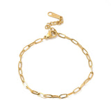 golden flat paperclip chain bracelet with lobster claw clasp and extender chain over white background. 