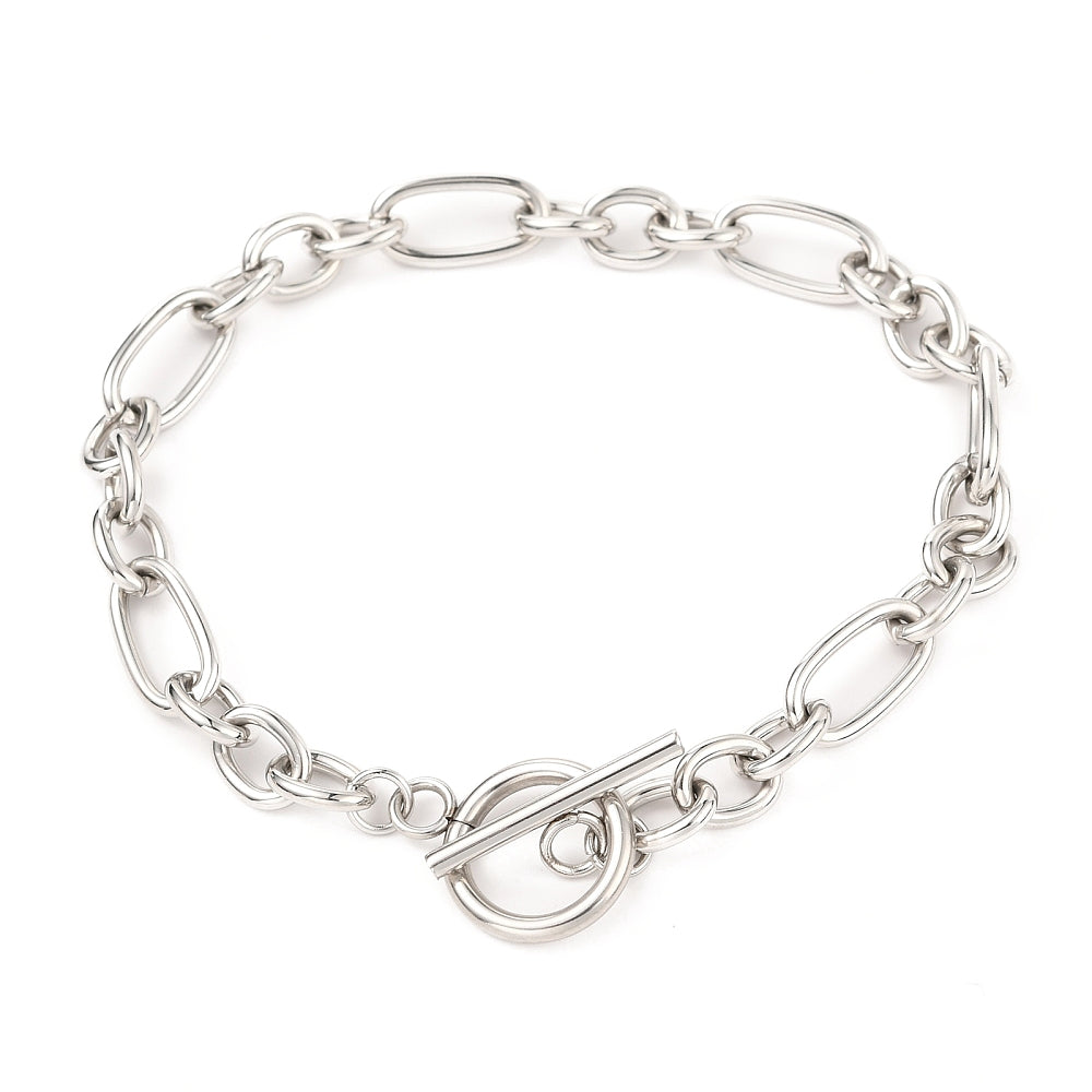 silver Figaro chain bracelet with toggle clasp on white background. 