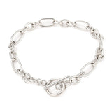 silver Figaro chain bracelet with toggle clasp on white background. 