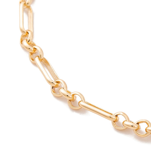 zoomed in section of oval Figaro link chain over white background. 