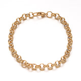 golden rolo chain bracelet with lobster claw clasp over white background .