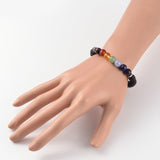 black lava rock stretch chakra bracelet featuring seven round chakra stone beads between smooth silver tone spacer beads displayed on mannequin wrist over a white background. 