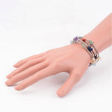 wrap bracelets made from piece of memory wire interspersed with tube beads along with clear quartz, jasper, citrine, carnelian, aventurine, lapis, and amethyst beads displayed around a mannequin wrist over white background. 