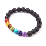 black lava rock stretch chakra bracelet featuring seven round chakra stone beads on white background. 