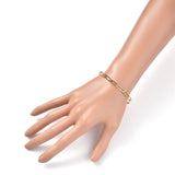 golden paperclip chain bracelet on mannequin hand over white background. 