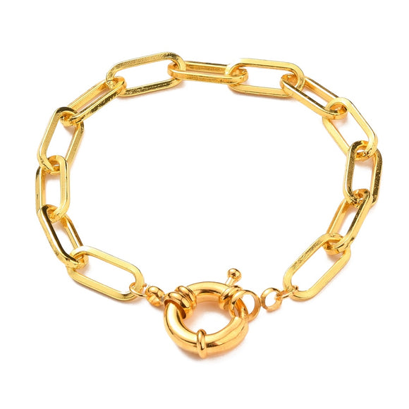 golden paperclip link bracelet with large spring ring clasp on white background. 