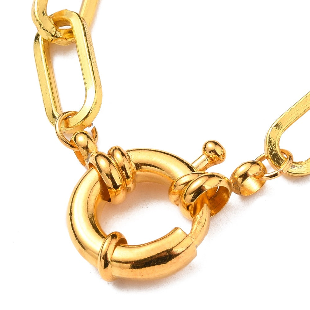 zoomed in golden large spring ring clasp on paperclip link bracelet over a white background. 