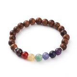 wooden chakra bead stretch bracelet with seven round chakra stone beads between silver spacer bead over white background.  