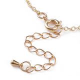 zoomed in spring ring with extender chain on fine cable chain over white background. 