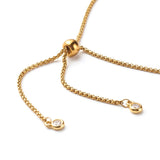 zoomed in section of adjustable golden rope chain with slider bead and bezel set clear stone stopper beads over white background. 