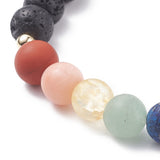 zoomed in section of black lava rock stretch chakra bracelet showing the round black lava rock beads, round gold spacer beads, round red, orange, yellow, green and part of blue chakra stone beads over a white background. 
