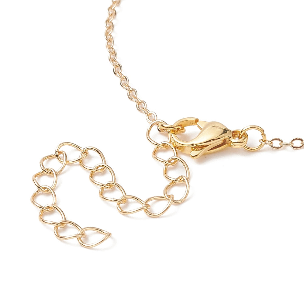 zoomed in section of golden lobster claw clasp on cable chain over white background. 