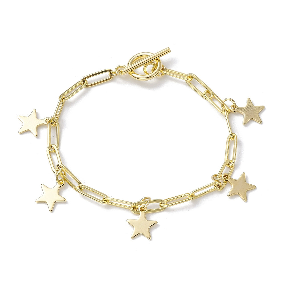 golden paperclip chain bracelet with five evenly spaced star charms and a toggle clasp over white surface. 
