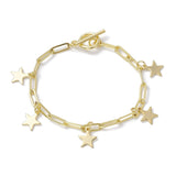 golden paperclip chain bracelet with five evenly spaced star charms and a toggle clasp over white surface. 