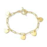 golden paperclip chain bracelet with toggle clasp and five evenly spaced heart charm dangles over white background. 