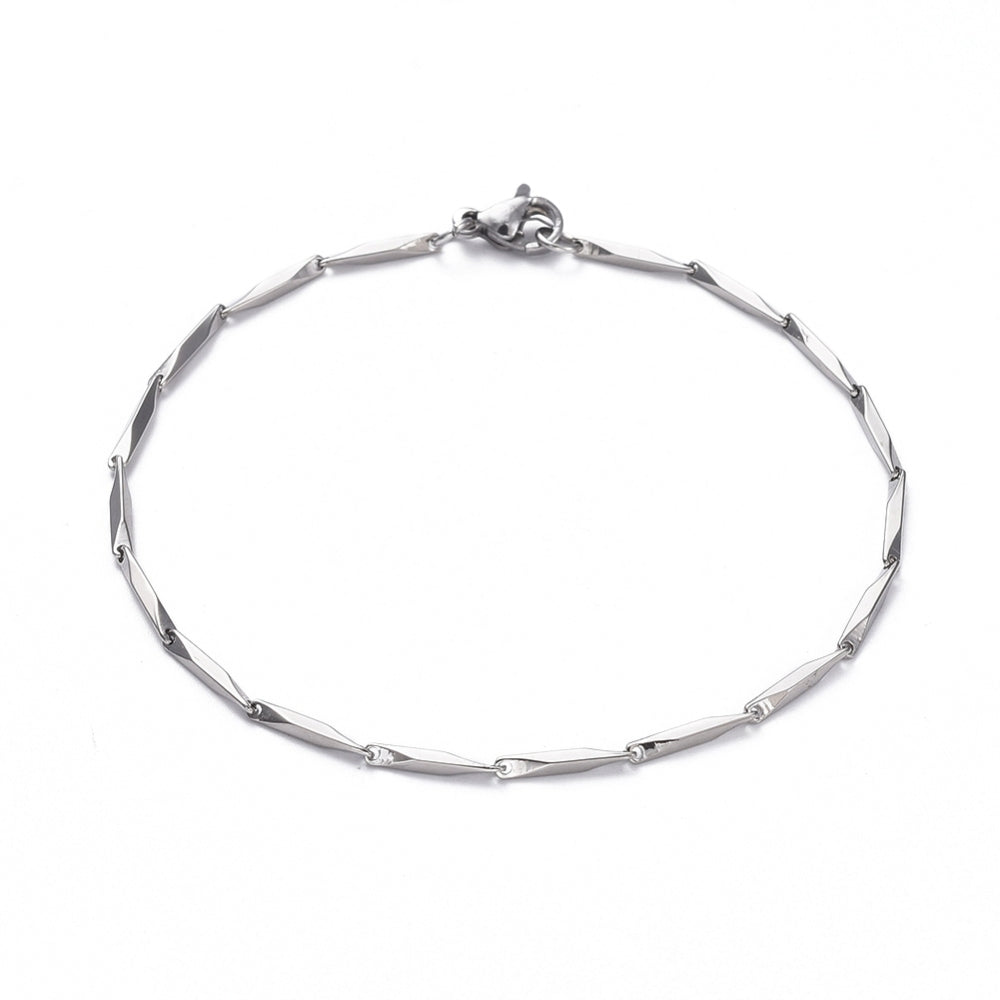 silver tone bar link chain bracelet with lobster claw clasp over white background.