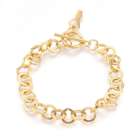golden large cable link bracelet with toggle clasp and key charm on white background. 