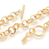 zoomed in sections of golden large cable link bracelet with toggle clasp and key charm on white background. 