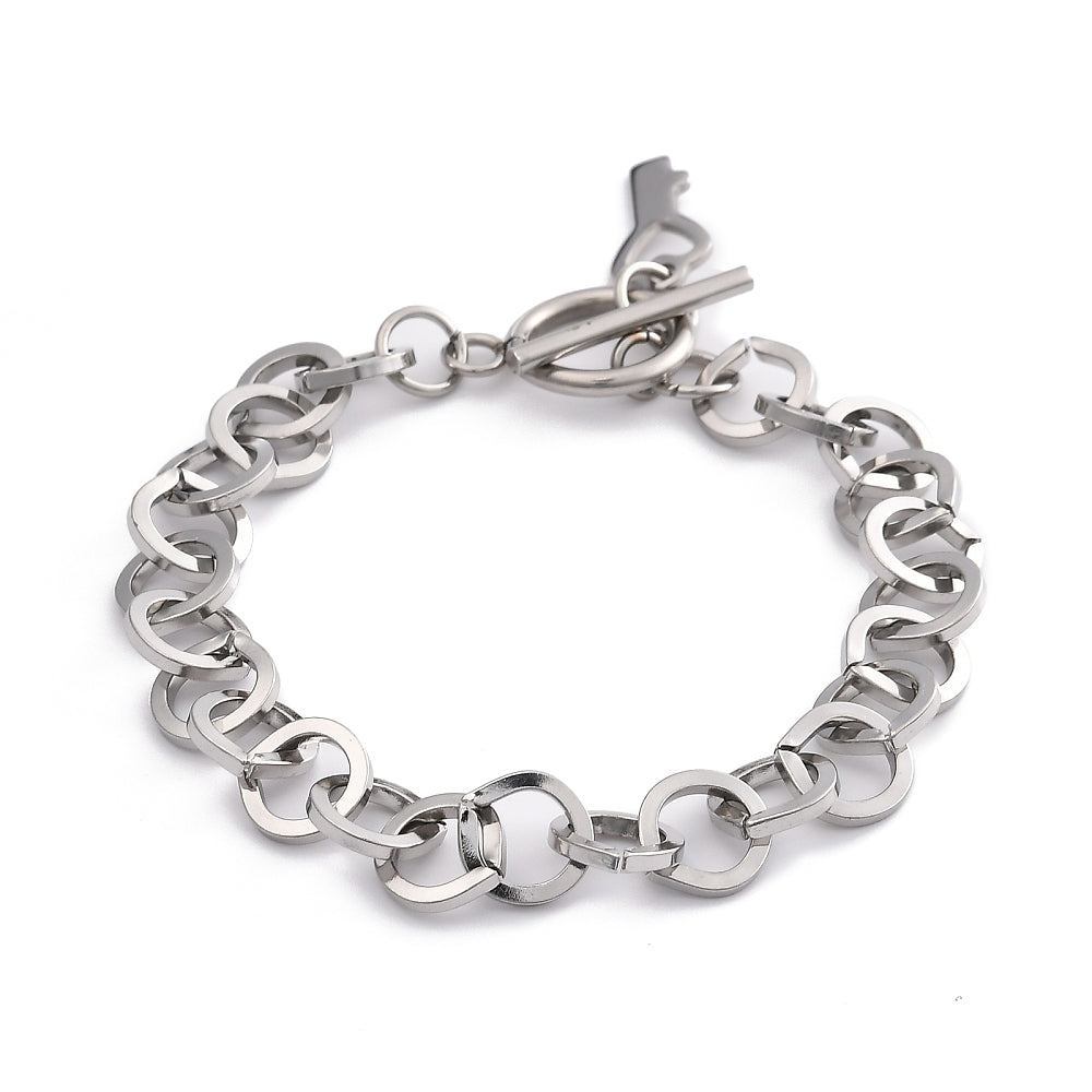 silver tone large cable link bracelet with toggle clasp and key charm on white background. 