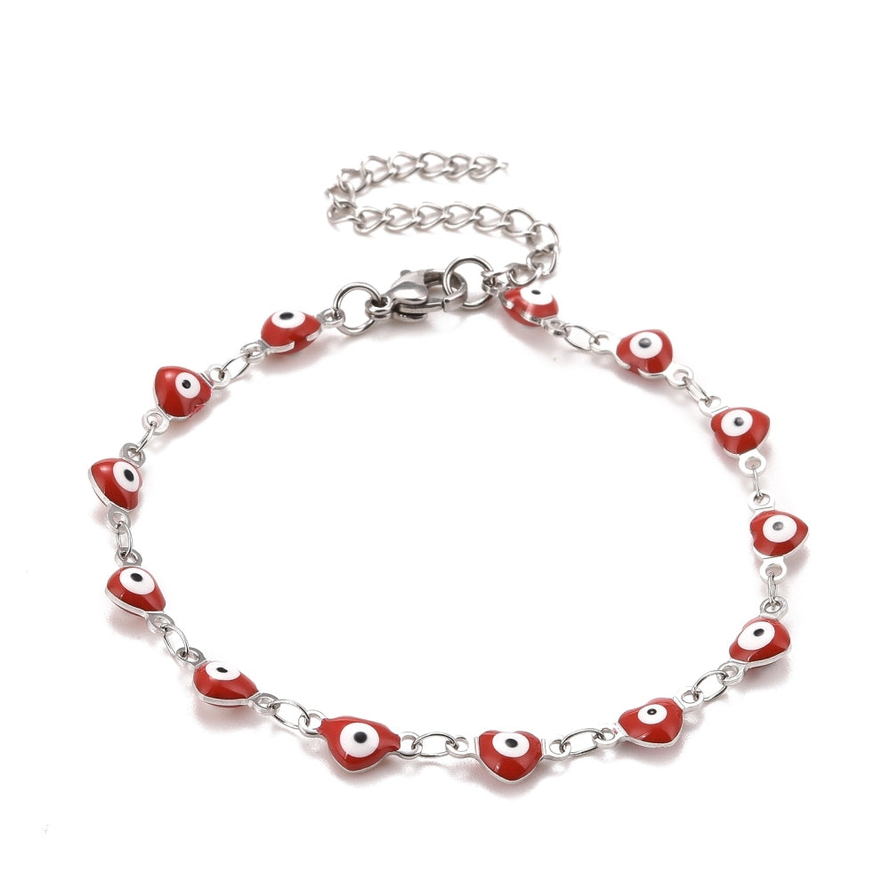 silver tone and red enamel heart shaped evil eye bracelet with lobster claw clasp and extender chain over white background.