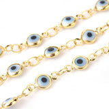 zoomed in sections of golden white and pale blue Evil Eye link chain necklace  over white background. 