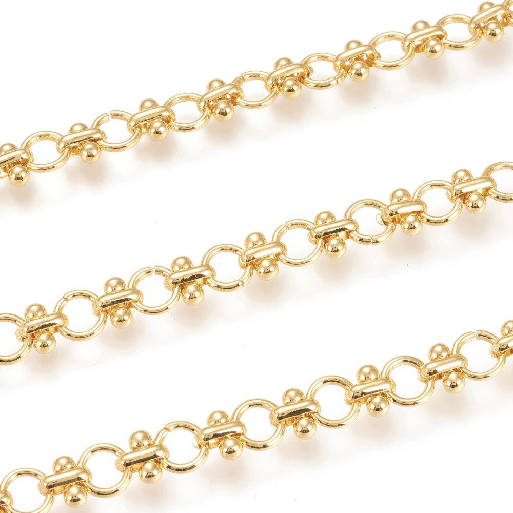 zoomed in sections of golden bar and circle link chain over white background. 