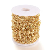 spool of golden bar and circle link chain over white background. 