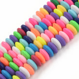 four bright multicolor polymer clay saucer bead strands over white background. 