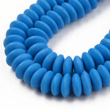 zoomed in sections of blue polymer clay saucer bead strands over white background. 