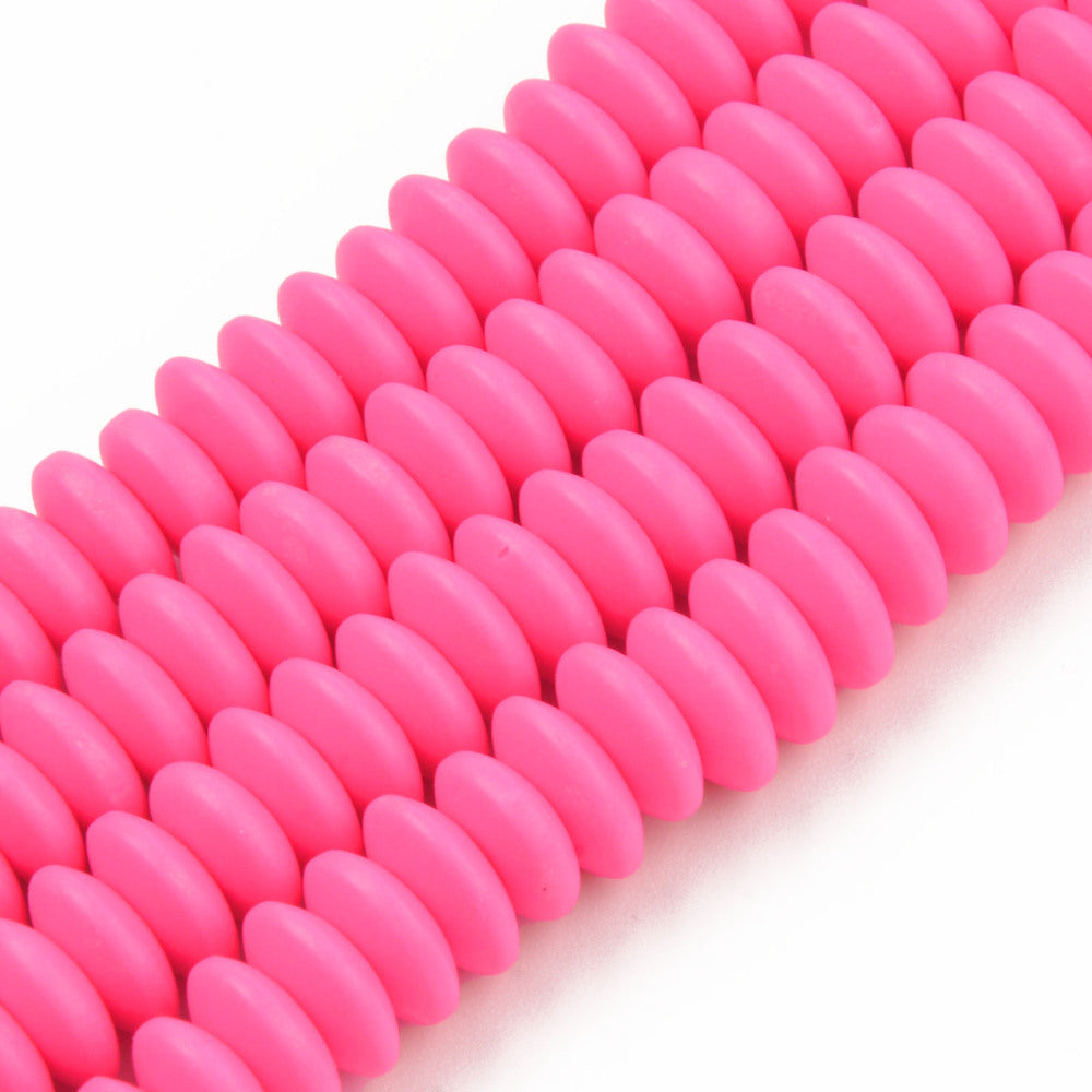 four pink polymer clay saucer bead strands over white background. 