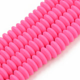four pink polymer clay saucer bead strands over white background. 