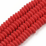four red polymer clay saucer bead strands over white background. 