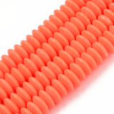 four orange polymer clay saucer bead strands over white background. 