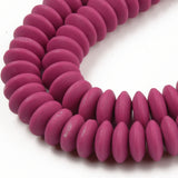 zoomed in sections of maroon polymer clay saucer bead strands over white background. 