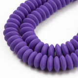 zoomed in sections of purple polymer clay saucer bead strands over white background. 