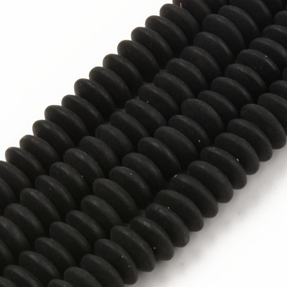 four black polymer clay saucer bead strands over white background. 