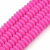 four fuchsia polymer clay saucer bead strands over white background. 