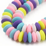 zoomed in sections of pastel multicolor polymer clay saucer bead strands over white background. 
