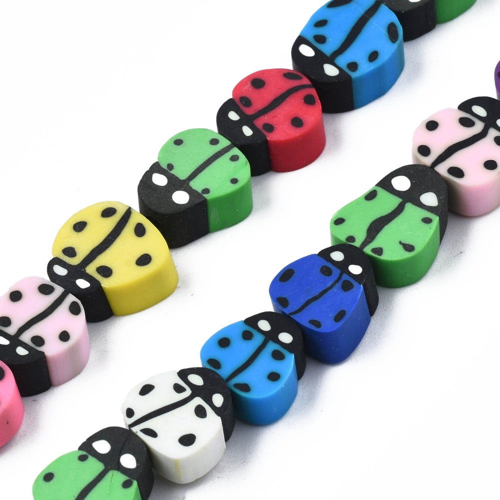 zoomed in sections of multicolor polymer clay ladybug bead strands over white background. 